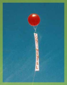 red helium advertising balloon with vertical banner