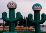Advertising Inflatables - Giant Inflatable football player inflatables with saguaro cactus bodies.