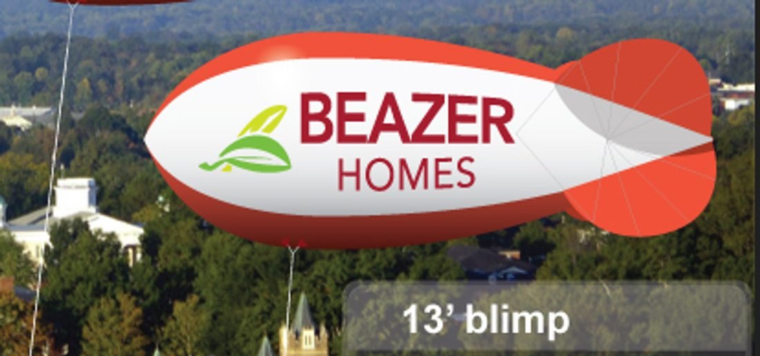 13 ft polyurethane advertising blimp with Beazer Homes lettering flying on a tether