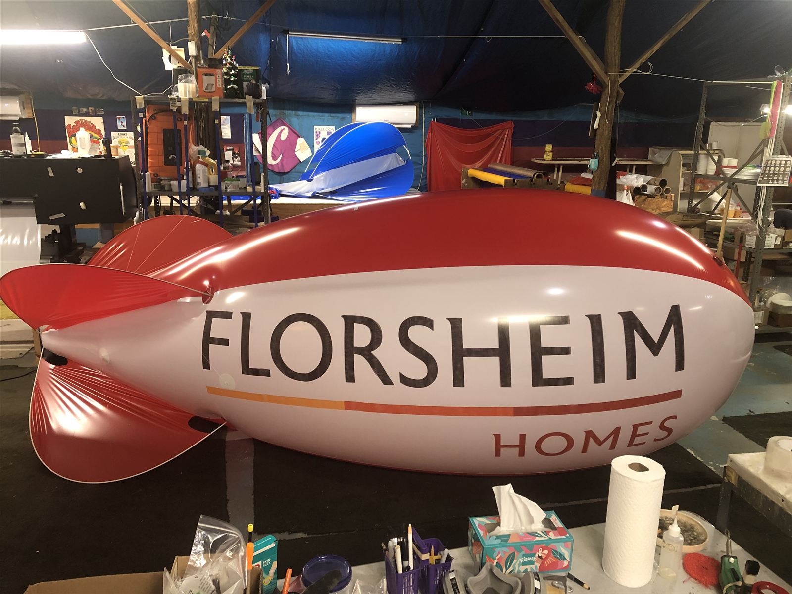 13 ft polyurethane advertising blimp for Florsheim Homes in the Arizona Balloon Company shop, showing stretched polyurethane fins on curved fiberglass rods